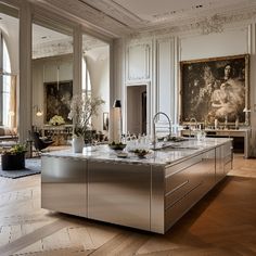 a large kitchen with stainless steel appliances and marble counter tops in an ornately decorated room