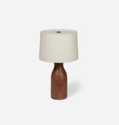 a small wooden table lamp with a white shade on the top and bottom part of it