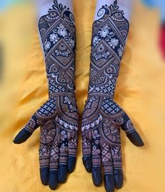 two hands with henna designs on them