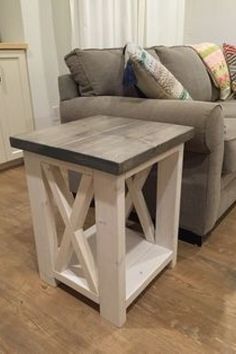 a living room with a gray couch and wooden table