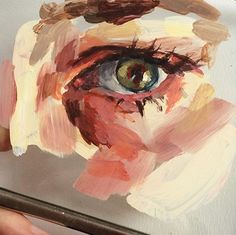 someone is painting an eye on a canvas with colored pencils and watercolor paints