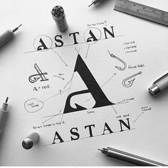 the logo for astan is surrounded by various pens and pencils on a table