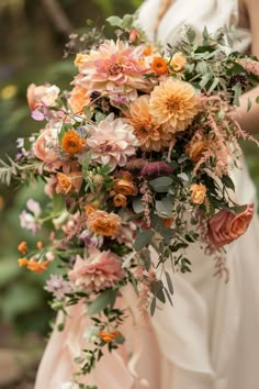 a woman holding a bouquet of flowers in her hands