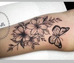 a woman's arm with flowers and butterflies on it