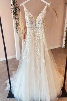 a wedding dress hanging on a rack in front of a mirror with the word passion written on it