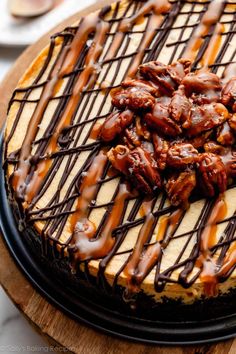 a cake with chocolate drizzle and pecans on top