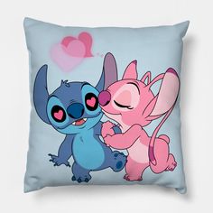 two cartoon characters hugging each other on a blue pillow with pink hearts in the background