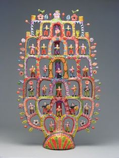 an elaborately decorated sculpture is displayed on a gray background