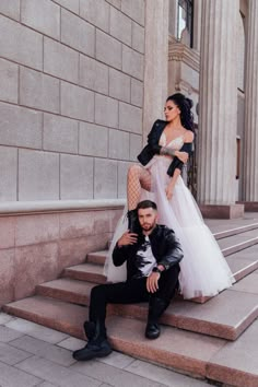 a man and woman posing on some steps