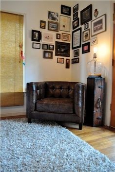 a living room filled with furniture and pictures on the wall