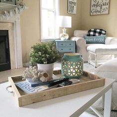 a living room filled with furniture and a fire place next to a white couch in front of a fireplace