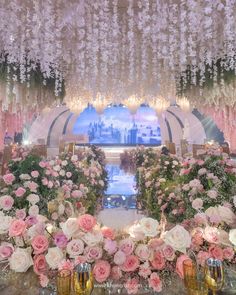 an elaborately decorated wedding ceremony with pink and white flowers