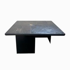 a black table that has some kind of design on it's surface and is in the shape of a rectangle