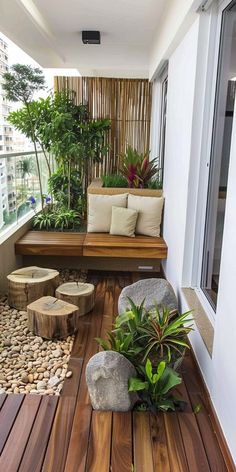 a wooden bench sitting on top of a wooden floor next to a lush green plant