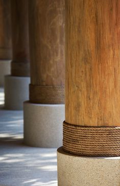 the columns are lined up with rope wrapped around each pillar, and they look like wood