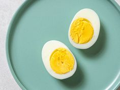 two hard boiled eggs on a blue plate