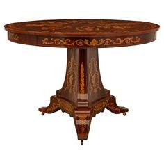 an ornately decorated wooden table with intricate carvings on the top and sides, against a white background