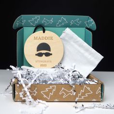 an open box with some paper on it and a tag that says maddie in the middle