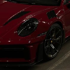 a red sports car parked in a parking lot