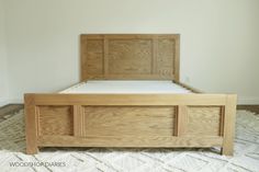 a wooden bed frame sitting on top of a white rug