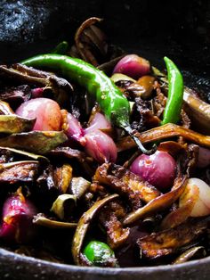 onions and peppers are being cooked in a skillet