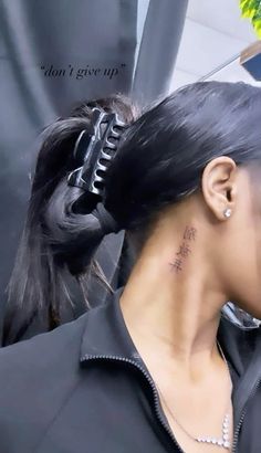 a woman with a tattoo on her neck is looking at the camera while she's getting her hair done