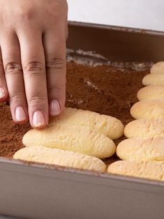 a person reaching for some cookies in a pan