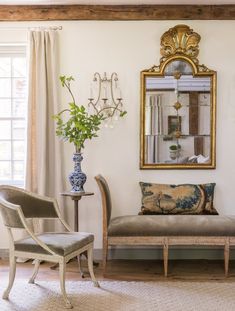 a living room filled with furniture and a mirror