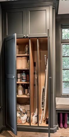 an open cabinet in the corner of a room