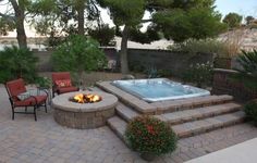 an outdoor hot tub surrounded by patio furniture