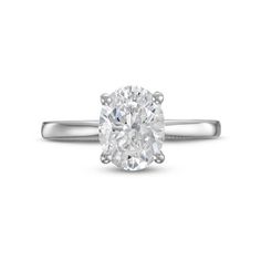 an oval cut diamond engagement ring on a white background