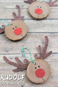 three christmas ornaments made out of wood slices with reindeer noses on them and glittery antlers