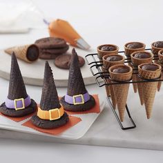 there are many desserts in cones on the table