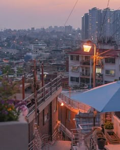 the city skyline is lit up at night with buildings in the background and an umbrella