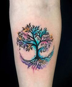 a colorful tree tattoo on the leg