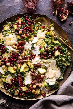 a salad with avocado, pomegranate and other vegetables