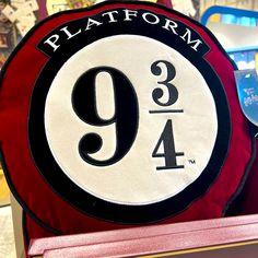 a red and black plate with the number nine on it in front of other items