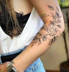 a woman with a flower tattoo on her arm