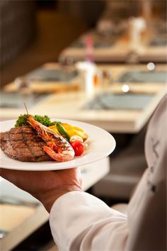 a person holding a plate with some food on it