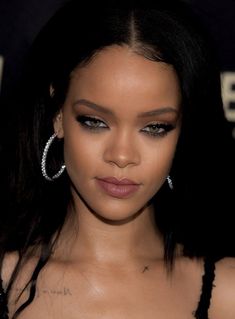 a close up of a person wearing large hoop earrings