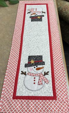 a table runner with a snowman on it