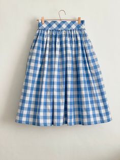 "Denim Blue check high waist full gathered skirt. Perfect for casual outfits and special ocasions with pair of trainters or high heels. 100% cotton.  Elastic at the back of waist.  Two side pockets. Midi lenght about 70cm + 5 cm waistband. Handmade in UK.  Model wears size S.  HOW TO CHOOSE A SIZE ?   Using a measuring tape, measure the smallest part of your waist.  SIZE CHART: (CM) XS - W: 66 CM S - W: 70 CM M - W: 74 CM  L - W: 78 CM  XL - W: 82 CM  CARE INSTRUCTIONS: Hand wash only, do not bleach, hang dry, do not tumble dry, press with a cool iron on the reverse side.  Please message me before purchasing so I can check availability. If you wish this skirt in any other fabric, shorter or longer \"send message to seller\" and we can try to make something especially for you. *Depends on c Plaid Cotton Lined Skirt Bottoms, Fitted Cotton Skirt For Picnic, Plaid Cotton Relaxed Skirt, Plaid Cotton Long Skirt, Plaid Long Cotton Skirt, Long Plaid Cotton Skirt, Spring Gingham Cotton Skirt, Spring Cotton Skirt For Picnic, Spring Cotton Skirt For Picnics