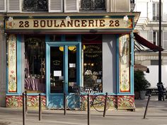 a store front with an ornately painted facade and bicycle parked outside the shopfront