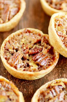 several pecan pies sitting on top of a wooden table