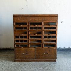 an old wooden cabinet with many drawers