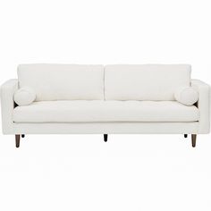 a white couch with two pillows on it