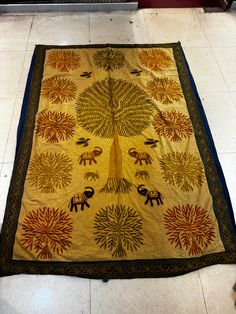 a large rug with an elephant and tree on it