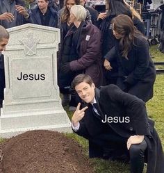 a man kneeling in front of a grave with the words jesus on it and people standing around