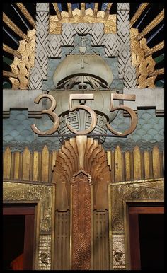 an elaborately designed building with gold and silver decorations on the front entrance to it