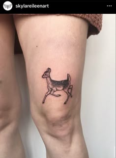 a small deer tattoo on the leg